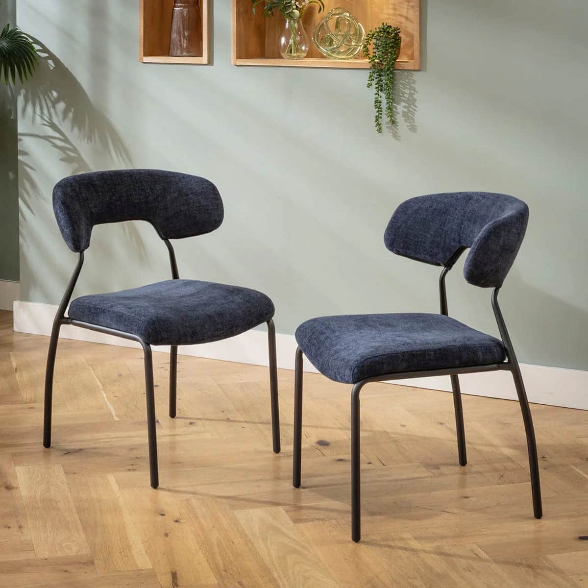 An armless chair featuring a dark blue upholstered seat and a separate, curved backrest, supported b… — free STL 3D model