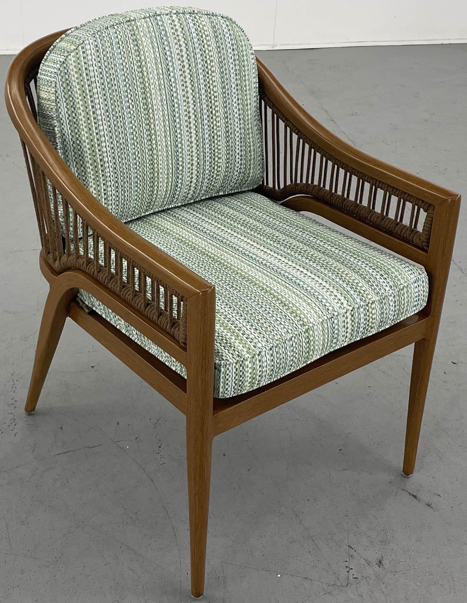 A barrel-back armchair featuring a warm-toned wooden frame, likely teak or oak, with distinctive wov… — free OBJ 3D model
