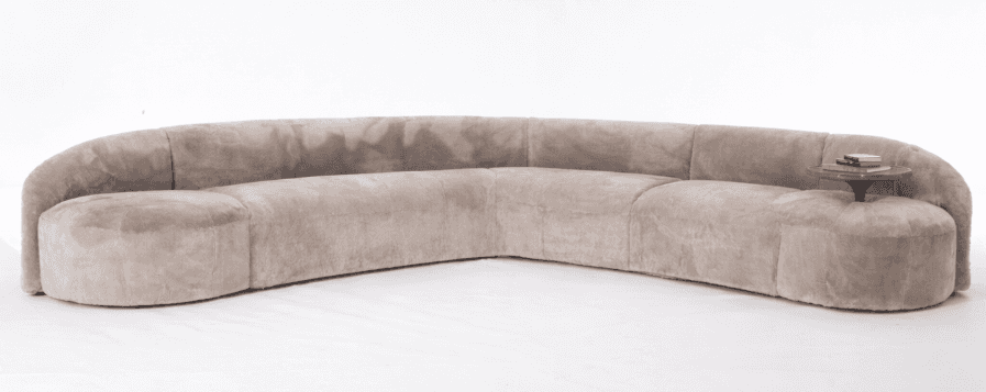 A large, curved sectional sofa with a smooth, plush upholstery. The sofa features a rounded, low-pro… — 3D model