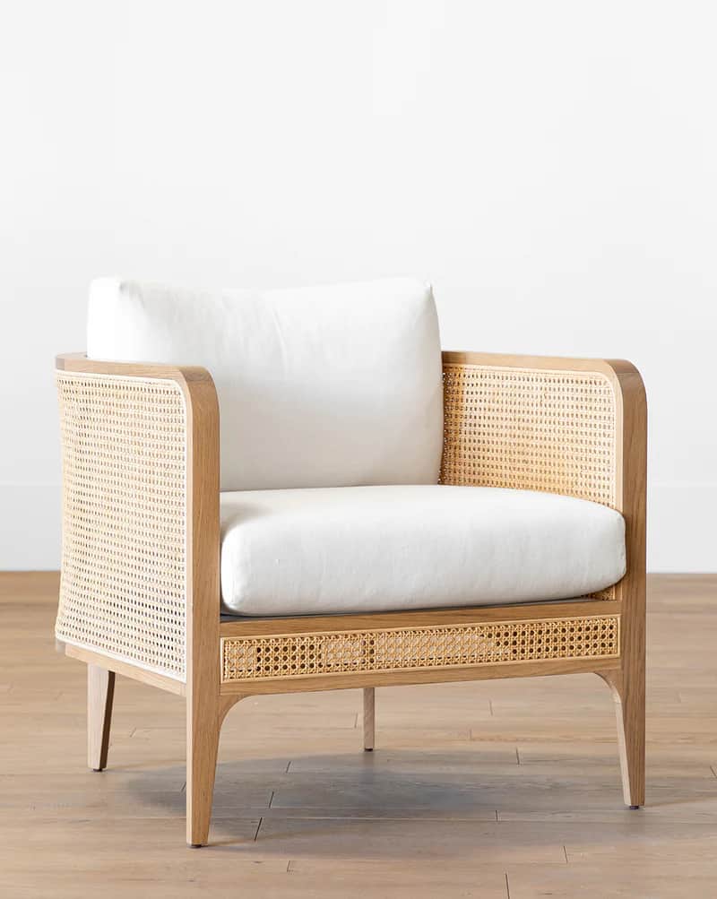 A wooden armchair with a cane woven back and sides, featuring a plush white seat and back cushion. T… — free OBJ 3D model