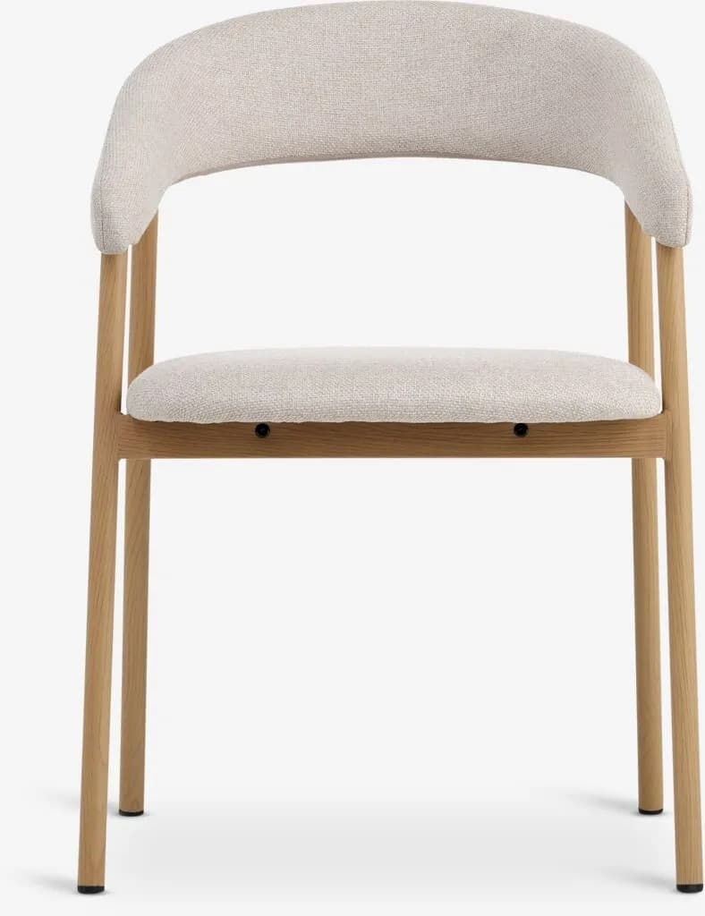 An upholstered dining chair featuring a light natural wood frame and a light beige, textured fabric. The backrest is gently curved, extending to form integrated armrests. The seat and back are fully upholstered, providing a soft seating experience. — 3D model