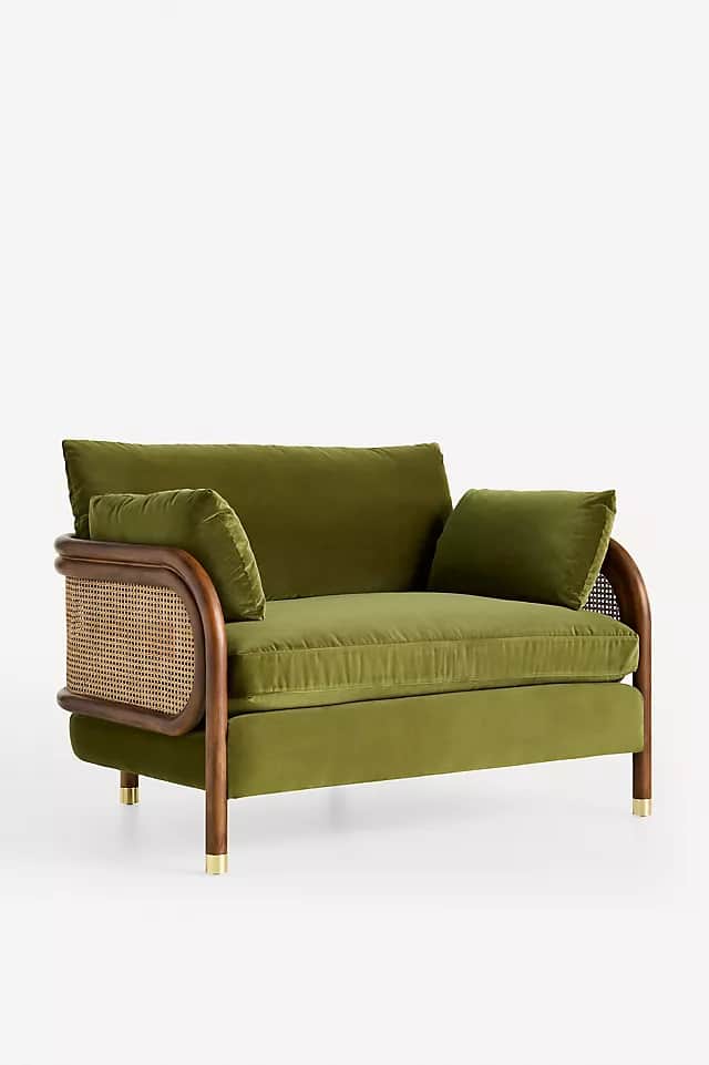 A contemporary lounge chair upholstered in olive green velvet, featuring a dark wood frame with curv… — 3D model