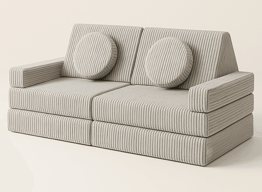 A contemporary two-seater modular sofa upholstered in a light grey ribbed or corduroy-like fabric with distinct vertical stripes. It features block-like construction, including two main seat cushions, two backrest cushions, and two integrated block armrests. Two round, matching accent cushions are placed against the backrests. — 3D model