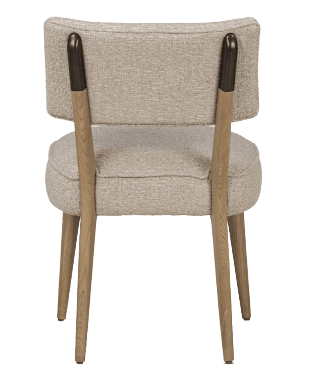 A view of the back of a upholstered armchair. The chair features a curved backrest and a cushioned seat. The legs and armrest accents are made of wood. The upholstery appears to be a textured, light-colored fabric. — 3D model