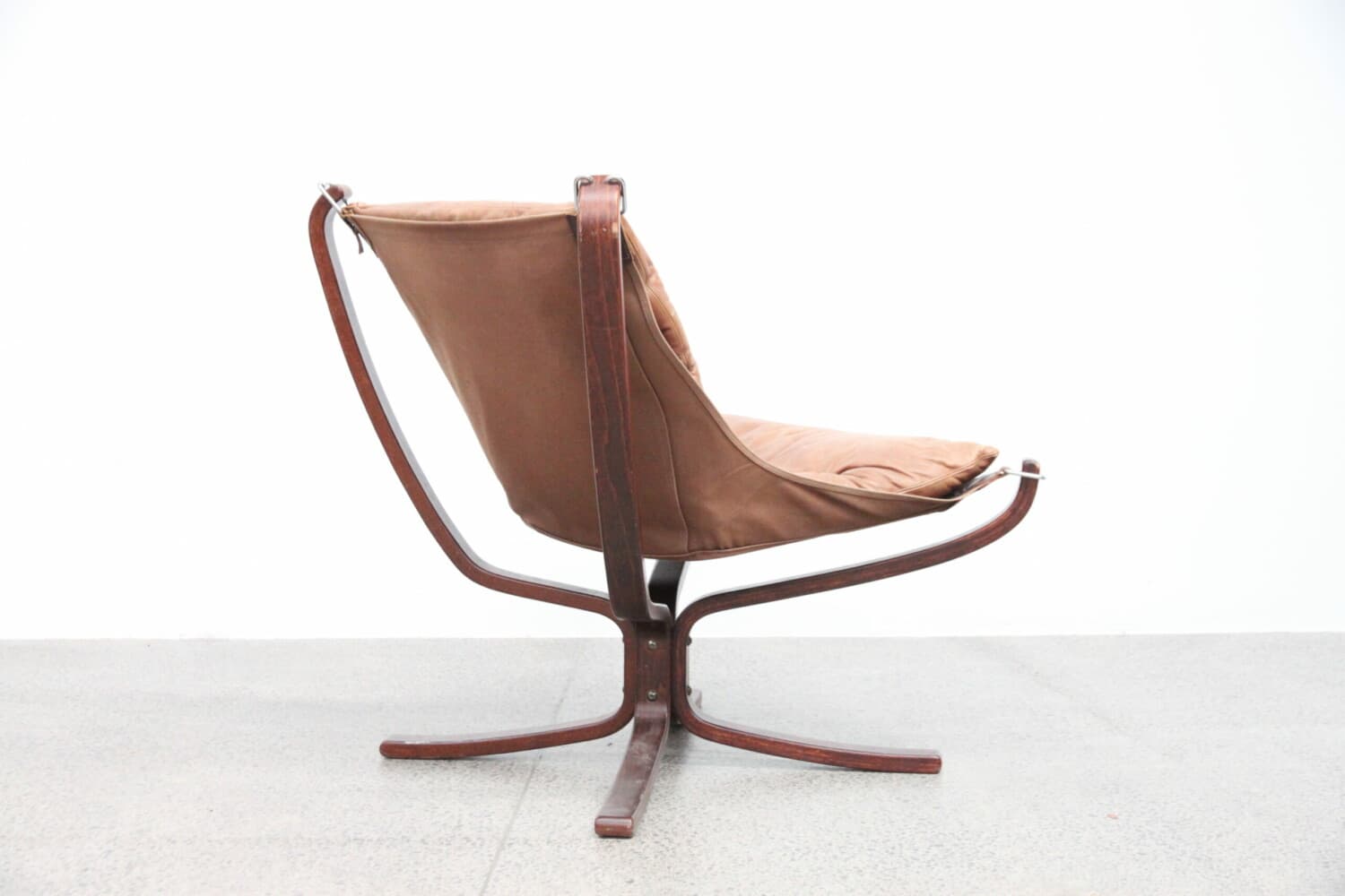 A mid-century modern lounge chair with a bentwood frame and upholstered seat and back. The frame consists of curved wooden elements forming the legs and arms, with a central pedestal base. The seat and back are made of a brown fabric or leather, with visible cushioning. — 3D model