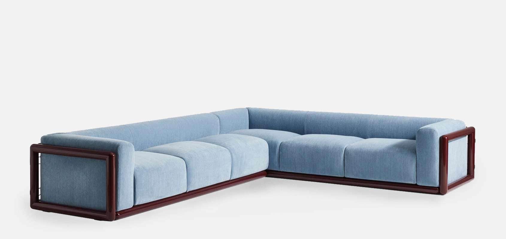 An L-shaped sectional sofa featuring a prominent dark wood frame and light blue fabric upholstery. T… — 3D model