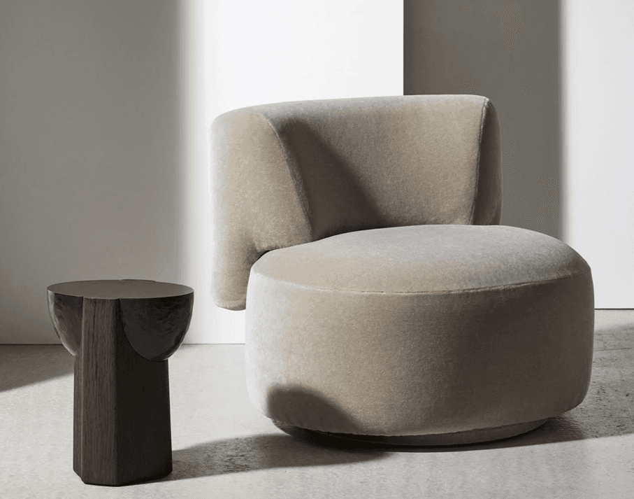 A contemporary, armless lounge chair upholstered in a light beige fabric, featuring a curved backres… — 3D model