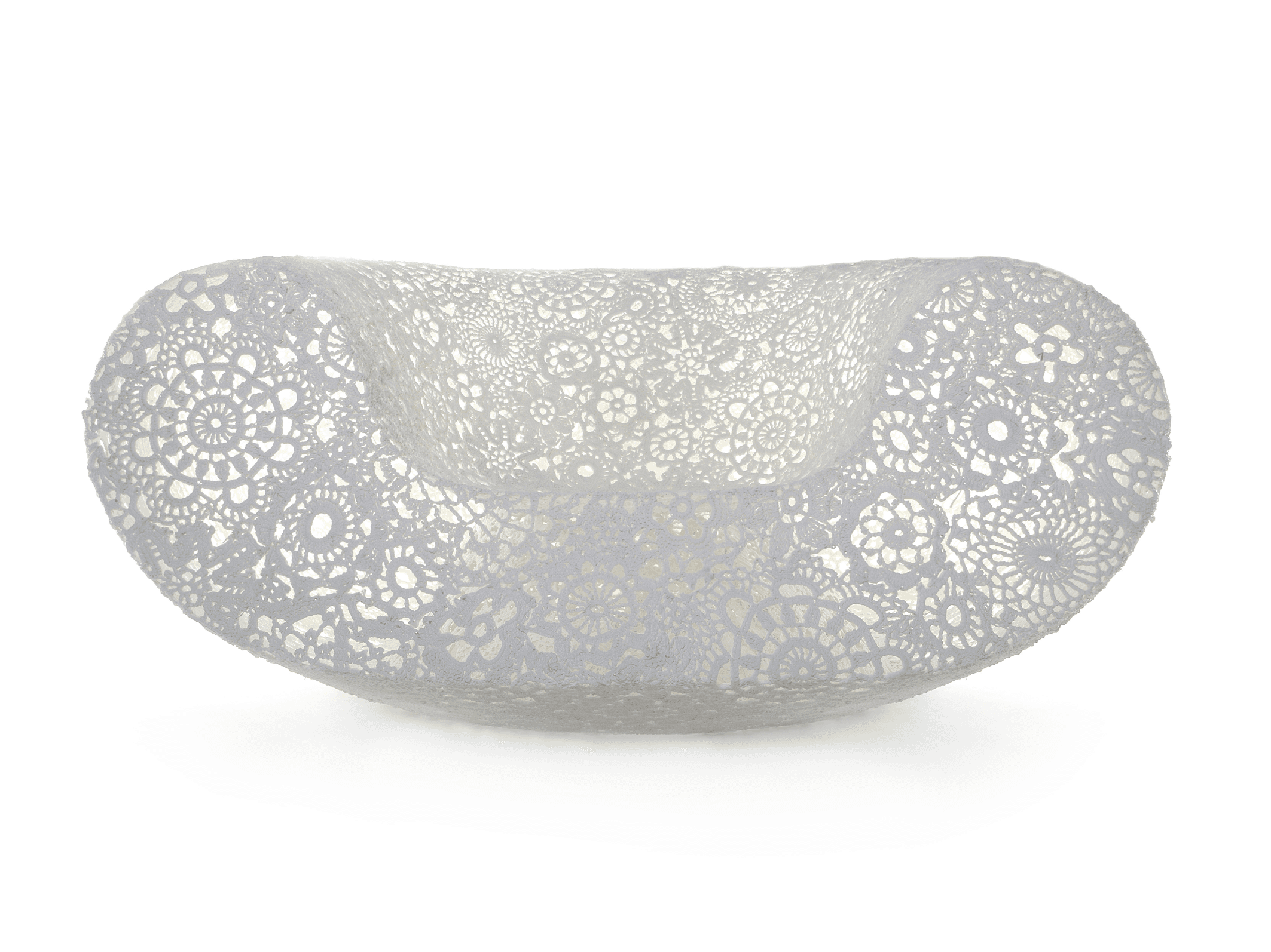 A modern, sculptural chaise lounge featuring an intricate, openwork crochet or lace-like pattern across its entire surface. The piece is curved and elongated, designed for comfortable reclining, and appears to be made from a light-colored, possibly synthetic resin material. — 3D model