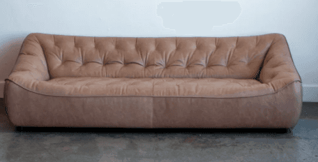 A contemporary sofa featuring an asymmetrical backrest and deep button tufting, upholstered in beige… — 3D model