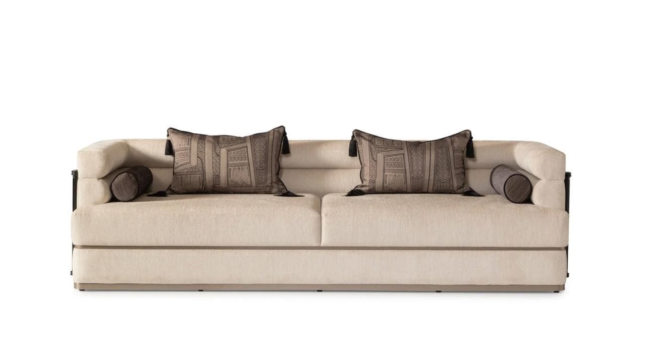 A modern upholstered sofa featuring a light-colored fabric, distinct dark wood and black metal arm detailing, and decorative throw pillows and bolster cushions. — 3D model