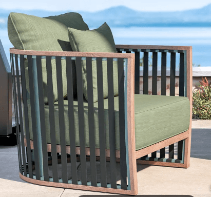A contemporary armchair with a curved frame and slatted sides. The armchair features a wooden base and frame, with vertical black slats forming the sides. It includes a seat cushion and two back cushions, all upholstered in a light green fabric. The overall design suggests suitability for outdoor or modern indoor use. — 3D model