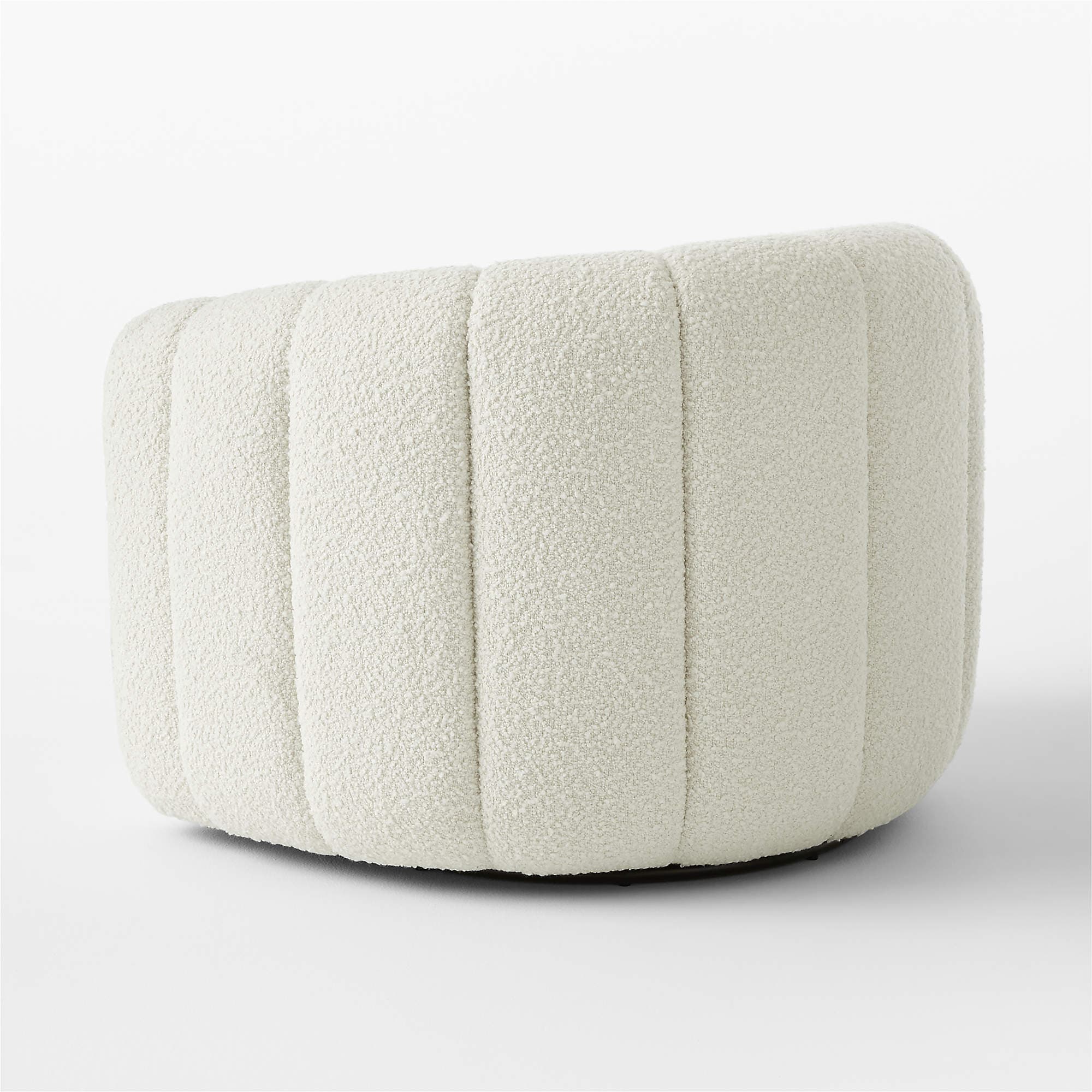 A cream-colored, rounded ottoman with vertical channel tufting across its exterior. The upholstery has a textured, boucle-like finish. The base appears to be dark and low-profile, supporting the cylindrical body of the ottoman. — 3D model