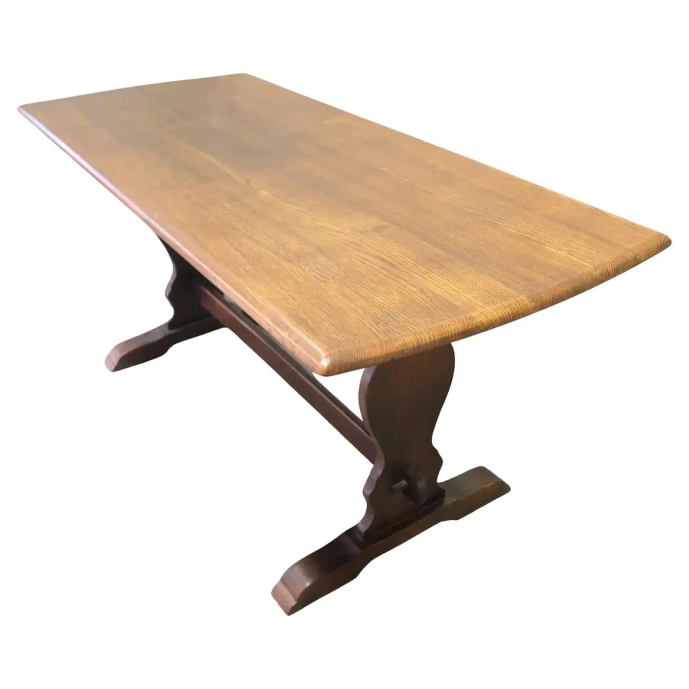 A rectangular dining table with a natural wood finish on the tabletop and a dark stained trestle base. The tabletop features a slightly curved edge and visible wood grain. The base consists of two arched supports connected by a central stretcher. — 3D model
