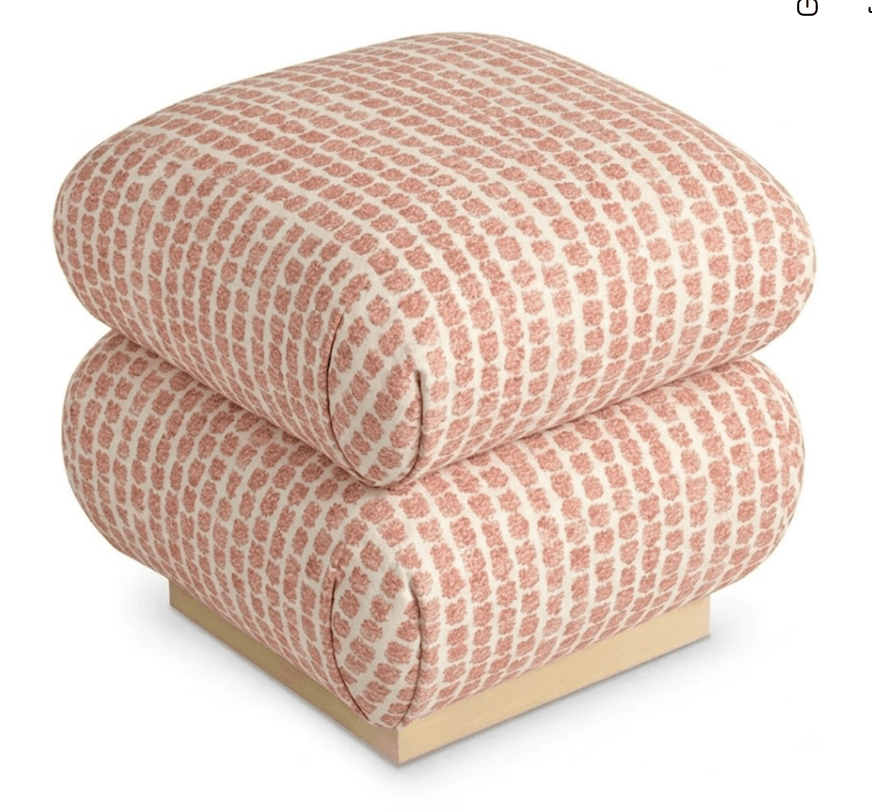 A contemporary ottoman featuring two stacked, rounded rectangular upholstered cushions with a geometric pattern, supported by a square, polished gold-finished metal base. — 3D model