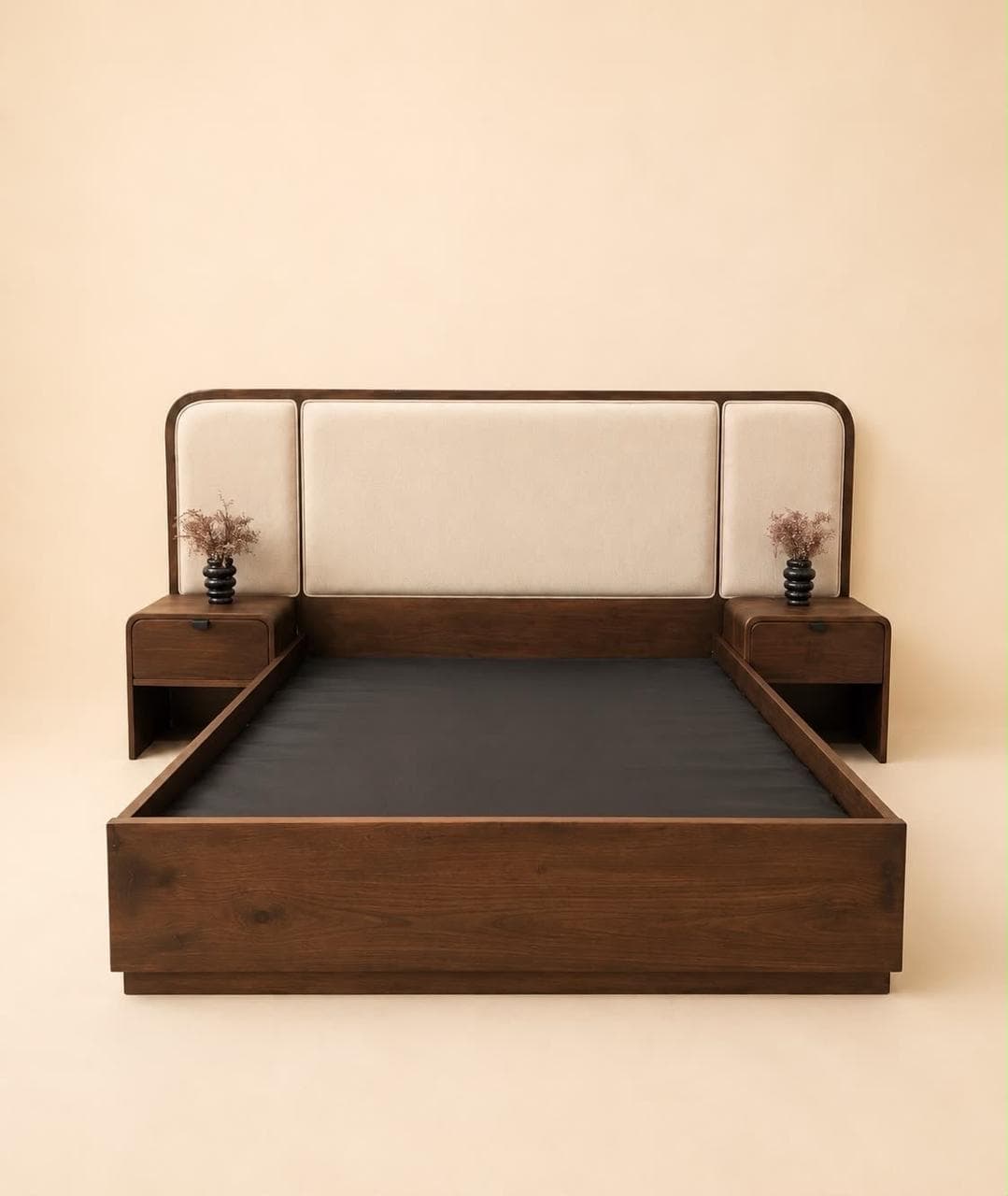 A contemporary platform bed made of dark walnut-finished wood, featuring an integrated upholstered headboard with light beige fabric panels and two attached nightstands with drawers and open shelves. — 3D model