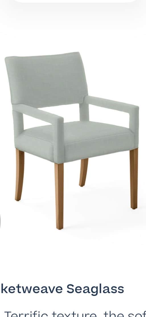 A light blue upholstered armchair with four wooden legs. The armchair has a rectangular backrest and… — 3D model