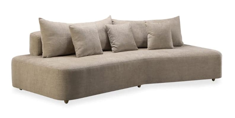 An armless modern sofa featuring a distinctive curved silhouette, upholstered in a textured beige fabric. It has a low-profile design with a continuous, gently curved body and rests on small, recessed wooden feet. The backrest is low and is complemented by several loose, rectangular back cushions of varying sizes, providing adaptable comfort. — 3D model