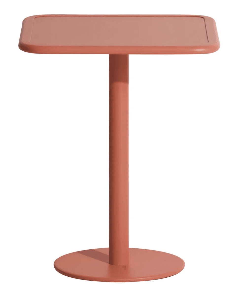 A modern side table with a square top featuring rounded corners. It has a single, cylindrical pedestal base that extends to a circular, flat base. The entire piece is a uniform salmon-pink color. — 3D model