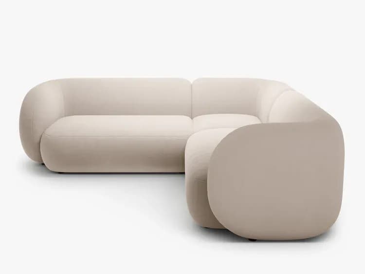 A modern sectional sofa with rounded, organic forms and a low profile. The sofa features deep, plush seating and a continuous upholstered frame that wraps around the corners, creating a soft, enveloping aesthetic. The back cushions appear integrated into the overall design. — 3D model