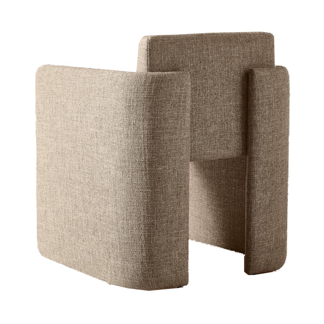 A contemporary armchair with a unique, geometric silhouette. The piece features a modular appearance with distinct, block-like sections forming the seat, backrest, and armrests. The upholstery is textured, suggesting a woven fabric. The overall form is solid and angular, yet the rounded edges of the visible surfaces provide a softer aesthetic. — 3D model