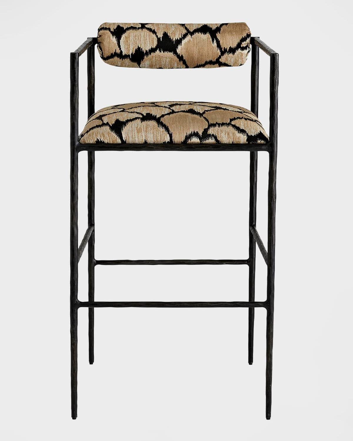 A modern bar stool featuring a slender black metal frame, an upholstered seat, and a cylindrical upholstered backrest. It includes integrated armrests and a built-in footrest. The upholstery features a distinctive geometric pattern in shades of beige/tan and black. — 3D model