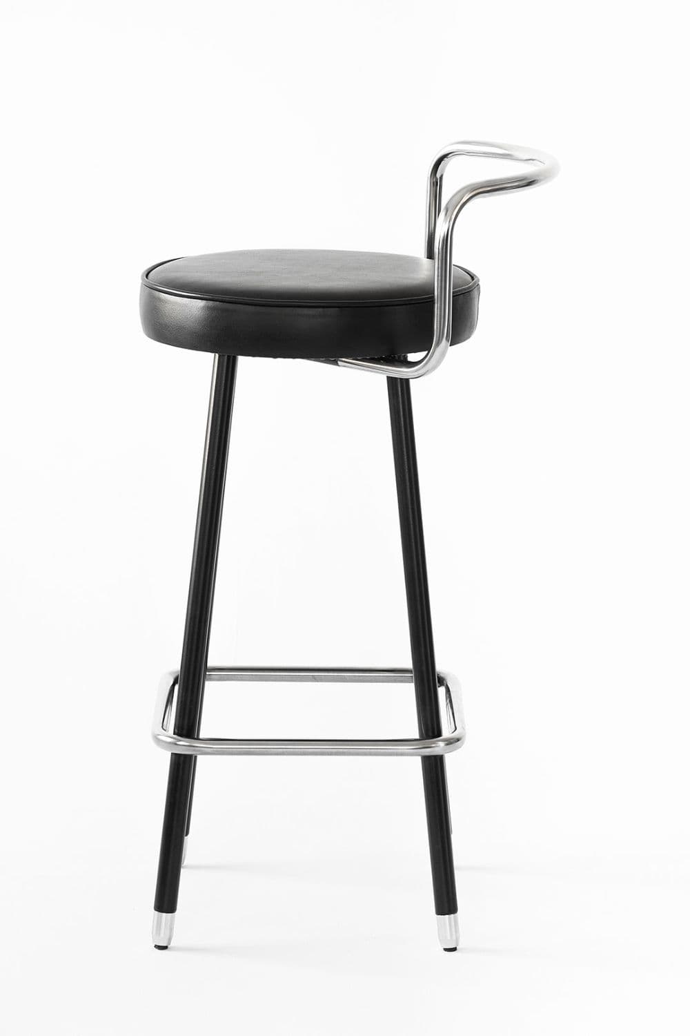 A contemporary bar stool with a round, padded black faux leather seat, supported by black metal legs, featuring a polished chrome footrest and an integrated, curved tubular chrome backrest. — 3D model
