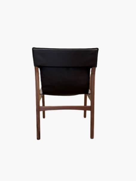 A modern armless chair with a dark wooden frame and a black sling-style upholstered back and seat, v… — 3D model