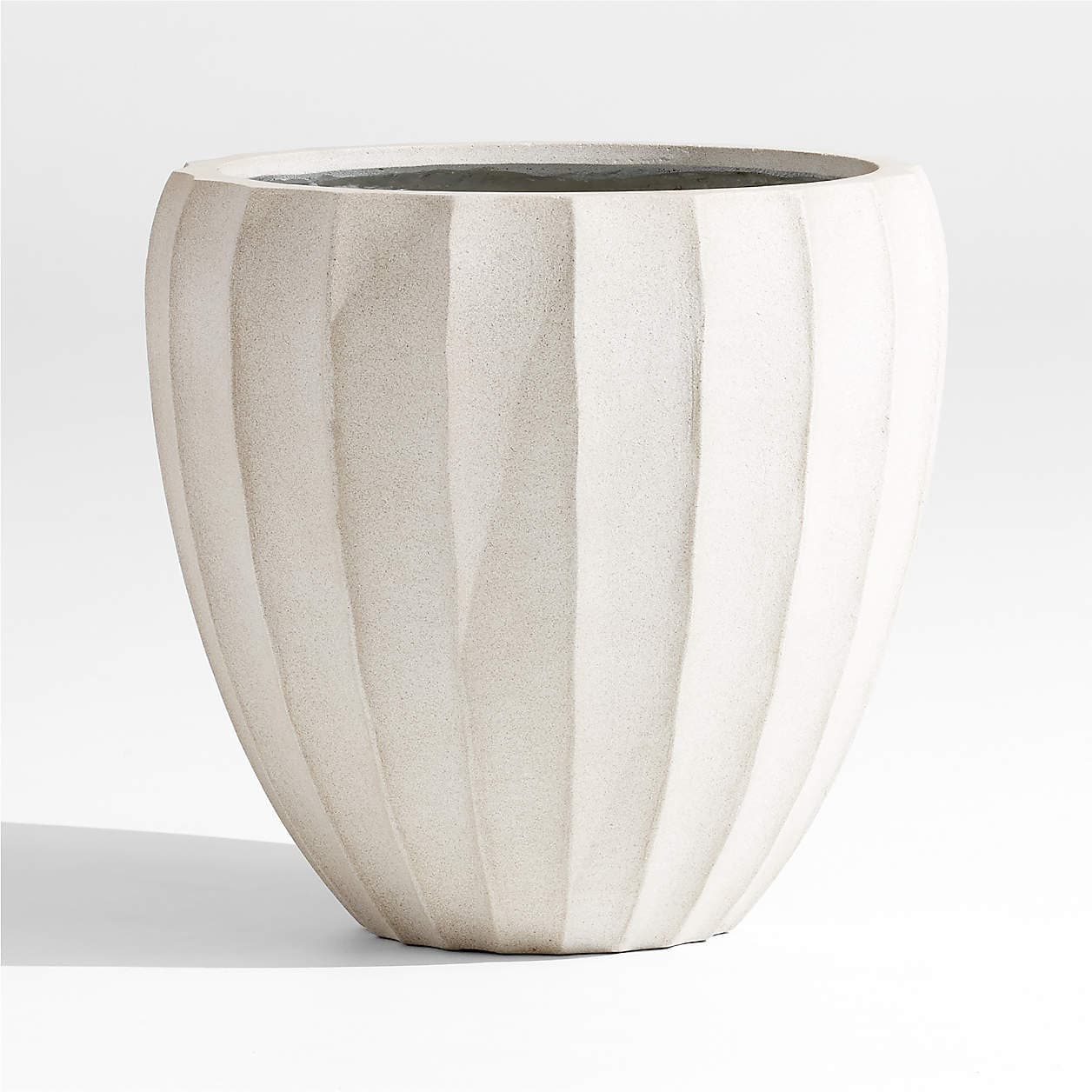 A large, off-white planter with a textured surface and vertical fluted detailing. The planter has a wide opening at the top, tapering down to a rounded base, and appears to be made of a concrete-like material. — 3D model