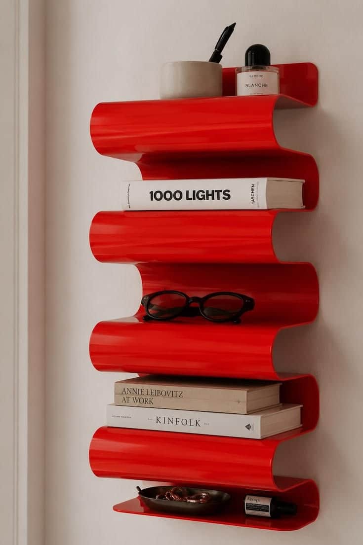 A tall, narrow, free-standing shelving unit featuring a distinctive serpentine or zig-zag design. It… — 3D model