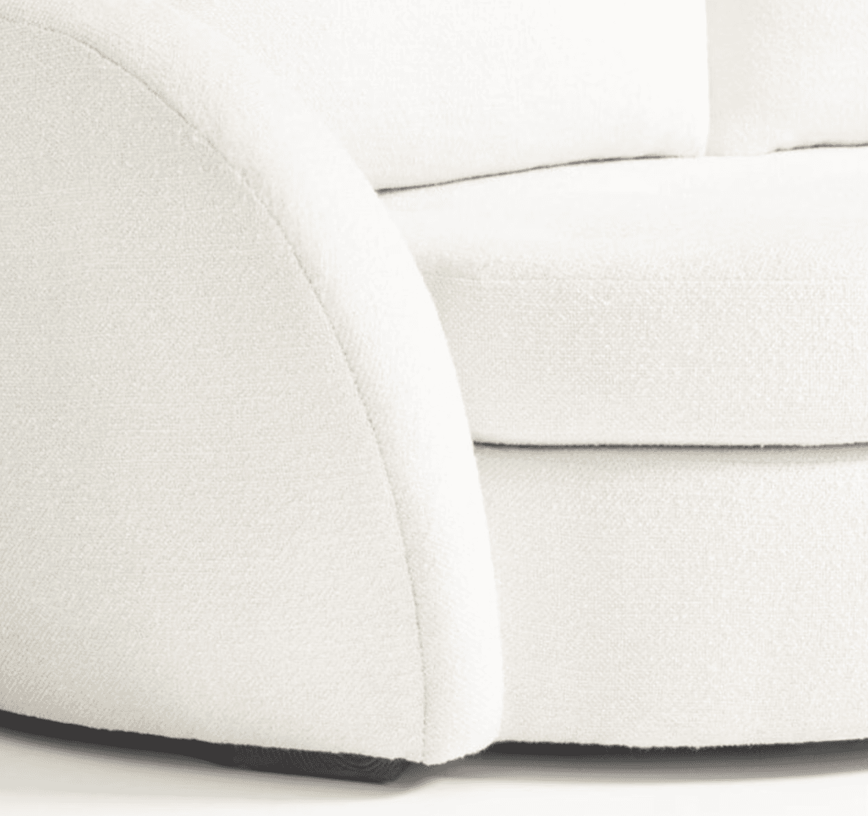 A close-up view of a cream-colored sofa, focusing on the armrest and seat cushions. The upholstery a… — 3D model