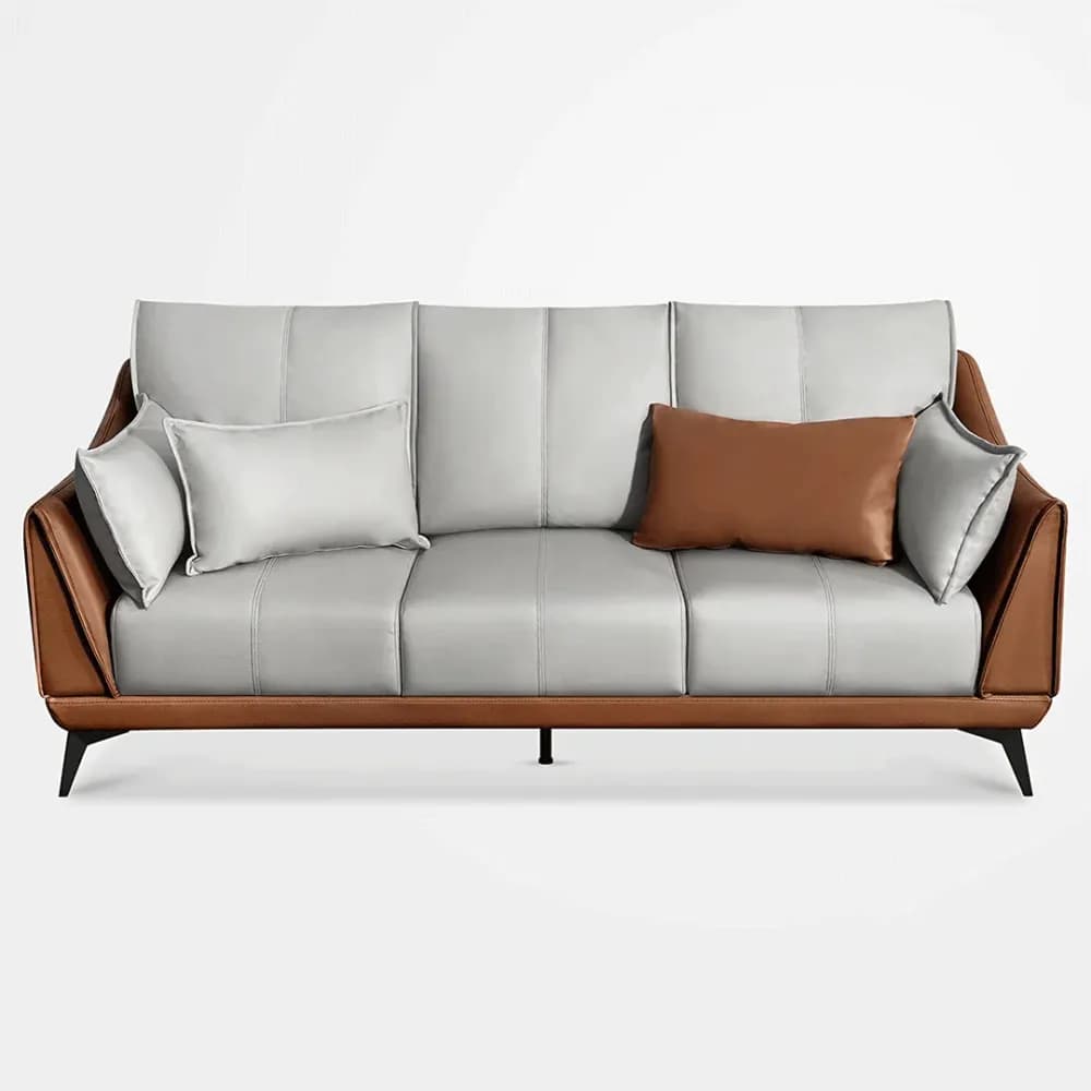 A contemporary three-seater sofa featuring a two-tone design with light grey upholstery for the back and seat cushions, contrasted by brown upholstery on the arms and lower frame. The sofa includes two light grey square throw pillows and one rectangular brown throw pillow. It sits on minimalist black metal legs, presenting a sleek and modern aesthetic. — 3D model