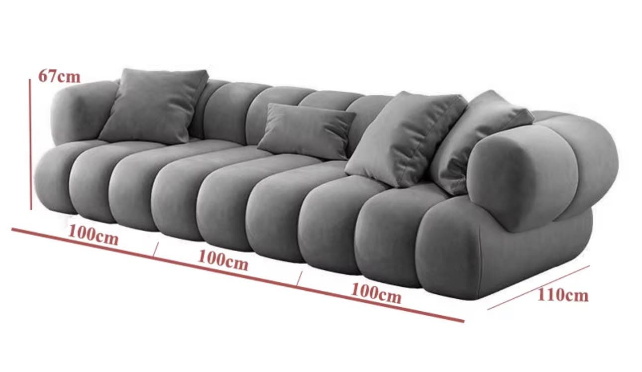 A long, contemporary sofa in a soft grey color, characterized by its distinctive 'bubble' or 'cloud-like' design where the entire body, including the seat, back, and arms, is formed by individual, plush, rounded upholstered sections. It is accompanied by several matching throw pillows. — 3D model