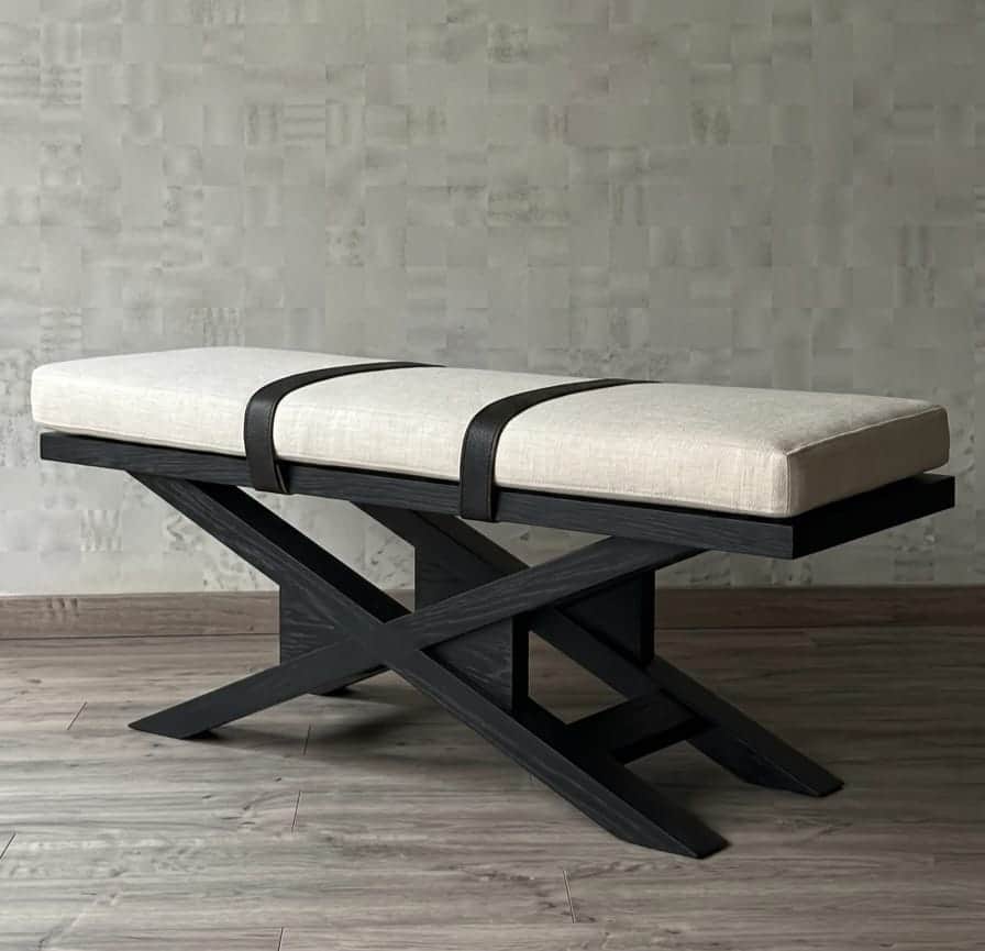A contemporary bench featuring a rectangular, upholstered cushion secured by decorative dark straps,… — 3D model