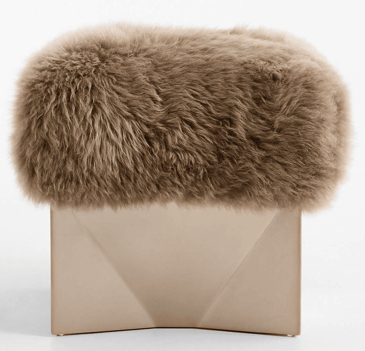 A modern ottoman featuring a textured, fur-like upholstered top and a geometric base. The top is rounded and appears to be made of a long-pile material, while the base is angular with faceted sides. — 3D model