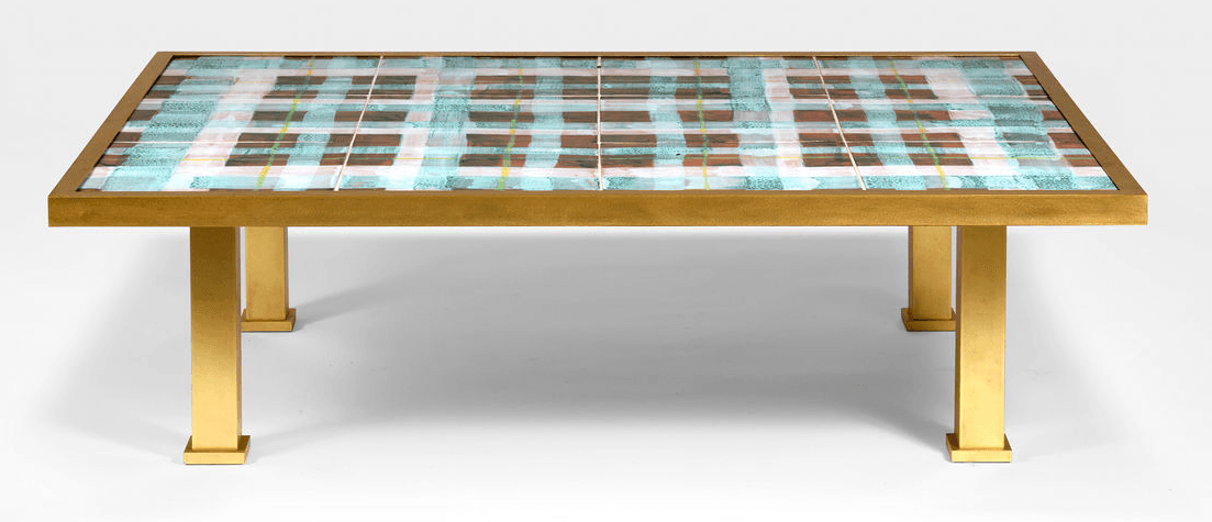 A rectangular coffee table with a gold-toned metal frame and legs. The tabletop features a decorative inlay with a plaid pattern created by bands of teal, brown, white, and yellow. The legs are thick and square-shaped, with a stepped base. — 3D model