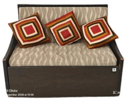 A compact daybed featuring a dark wood frame with integrated armrests and a backrest, upholstered with a light, wavy-patterned fabric cushion, and accented by three geometric throw pillows. — 3D model