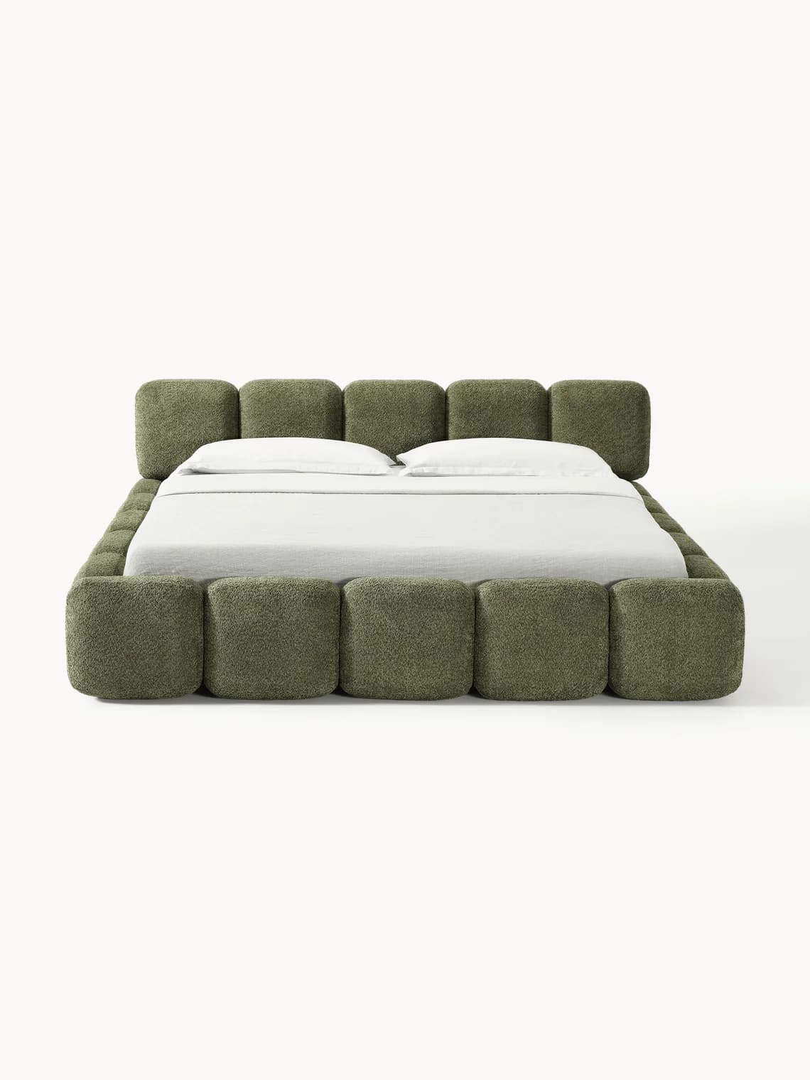 A low-profile bed frame upholstered in a textured, fuzzy fabric. The frame is modular, constructed from multiple square or cubic modules that form the headboard and the base. The headboard consists of six modules arranged linearly, while the base forms a continuous perimeter around the mattress. The mattress is covered with white bedding. — 3D model