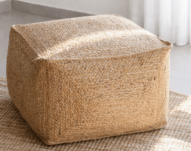 A square-shaped pouf ottoman covered in braided natural jute. The top surface features stitched seam… — 3D model