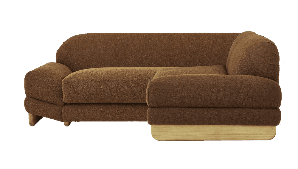 A sectional sofa with a rounded armrest on the left and a chaise lounge extending to the right. The upholstery is a textured brown fabric, and it sits on a light-colored wooden base. The sofa features plush cushioning. — 3D model