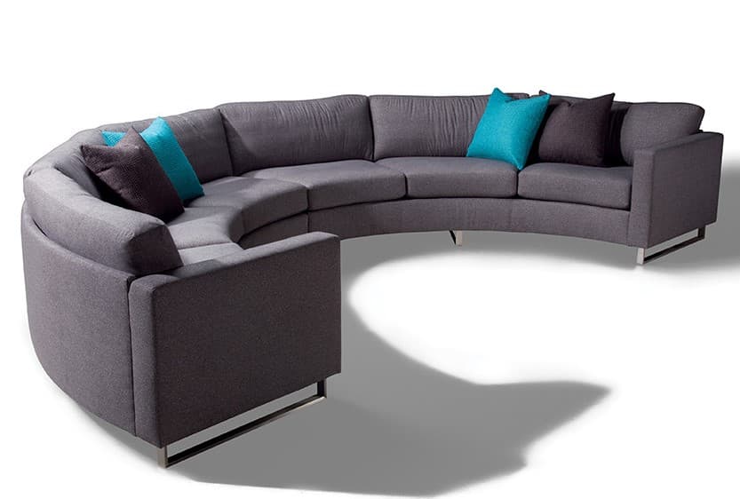 A large, curved sectional sofa with a modern design. It features a dark grey upholstered exterior with multiple seating sections. The sofa includes several accent pillows in teal and charcoal grey. The base is supported by thin, polished metal legs, creating a floating effect. — 3D model
