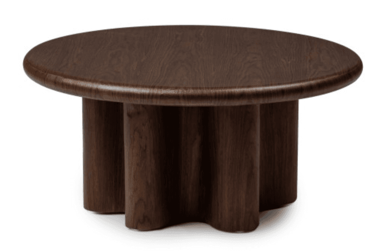 A low, round coffee table crafted from dark-stained wood, featuring a thick tabletop with a rounded edge and a distinctive, sculptural base composed of three large, rounded legs clustered centrally. — 3D model