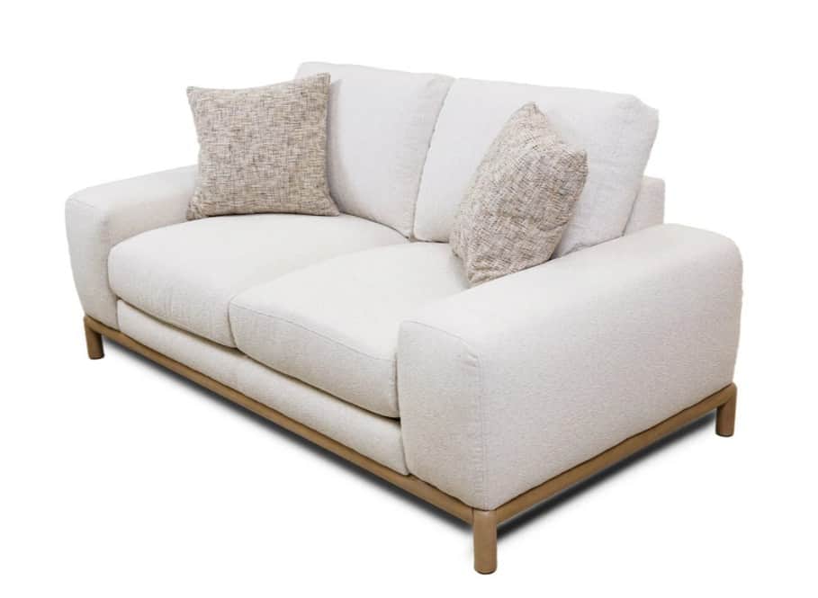 A modern, two-seater sofa featuring a plush, textured cream or off-white fabric upholstery. It has g… — 3D model