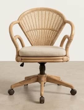 A light-colored, woven cane desk chair with a curved backrest and armrests. It features a padded sea… — 3D model