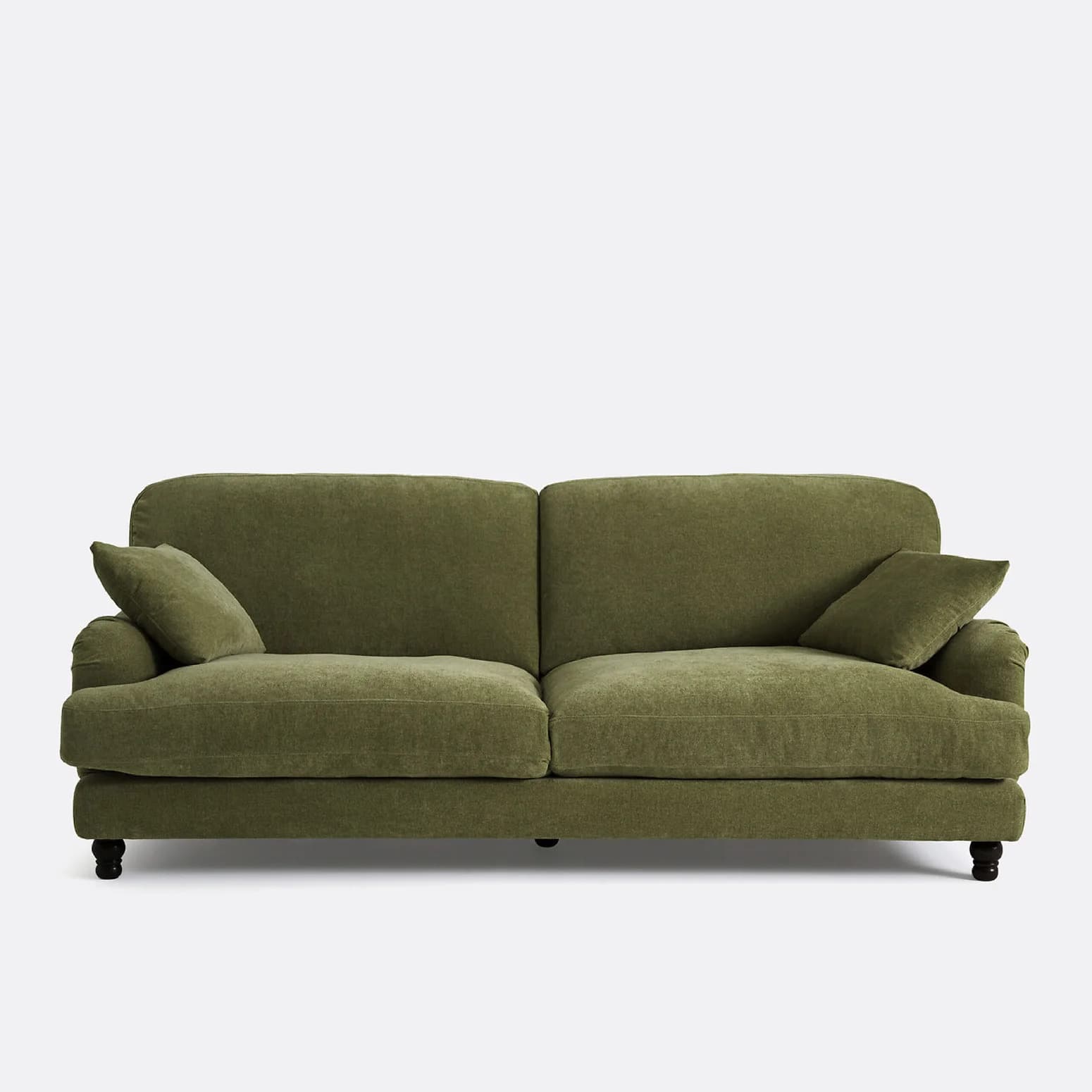 A traditional two-seater sofa upholstered in a textured olive green fabric. It features plush rolled arms, loose seat cushions, and loose back cushions, along with two accent throw pillows. The sofa rests on short, dark-stained turned wooden feet. — 3D model