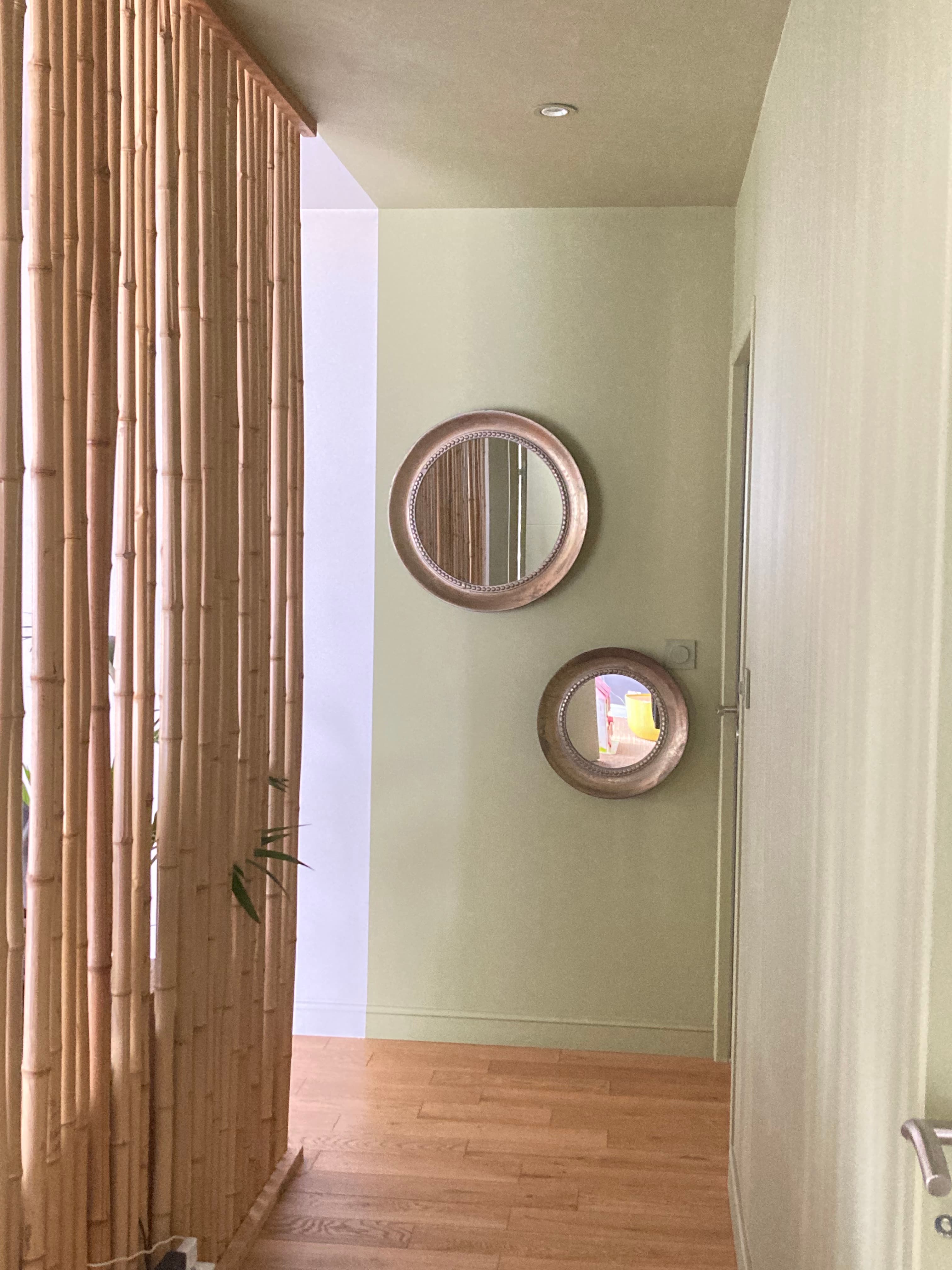 A vertical panel constructed from numerous individual bamboo poles, arranged closely together and connected horizontally. The poles are natural light brown, varying slightly in tone, forming a solid, tall barrier with an organic, textured appearance. — 3D model