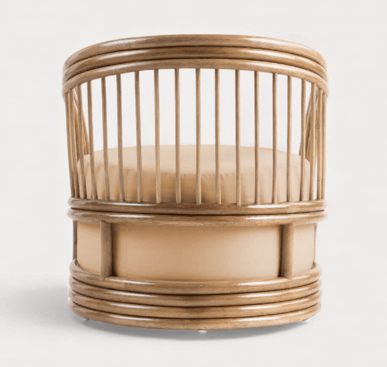 A barrel-shaped armchair constructed primarily from bentwood or cane, featuring a rounded backrest formed by vertical spindles connected to a top and bottom circular frame. The seat and lower body are upholstered in a light tan fabric. The base has subtle feet or glides. — 3D model