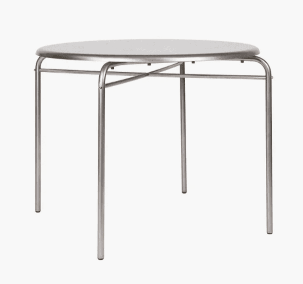 A modern round side table featuring a light gray or white tabletop supported by a tubular metal frame. The frame consists of four slender legs connected by a circular rim beneath the tabletop and an X-shaped cross brace for stability. The design is minimalist and functional. — 3D model