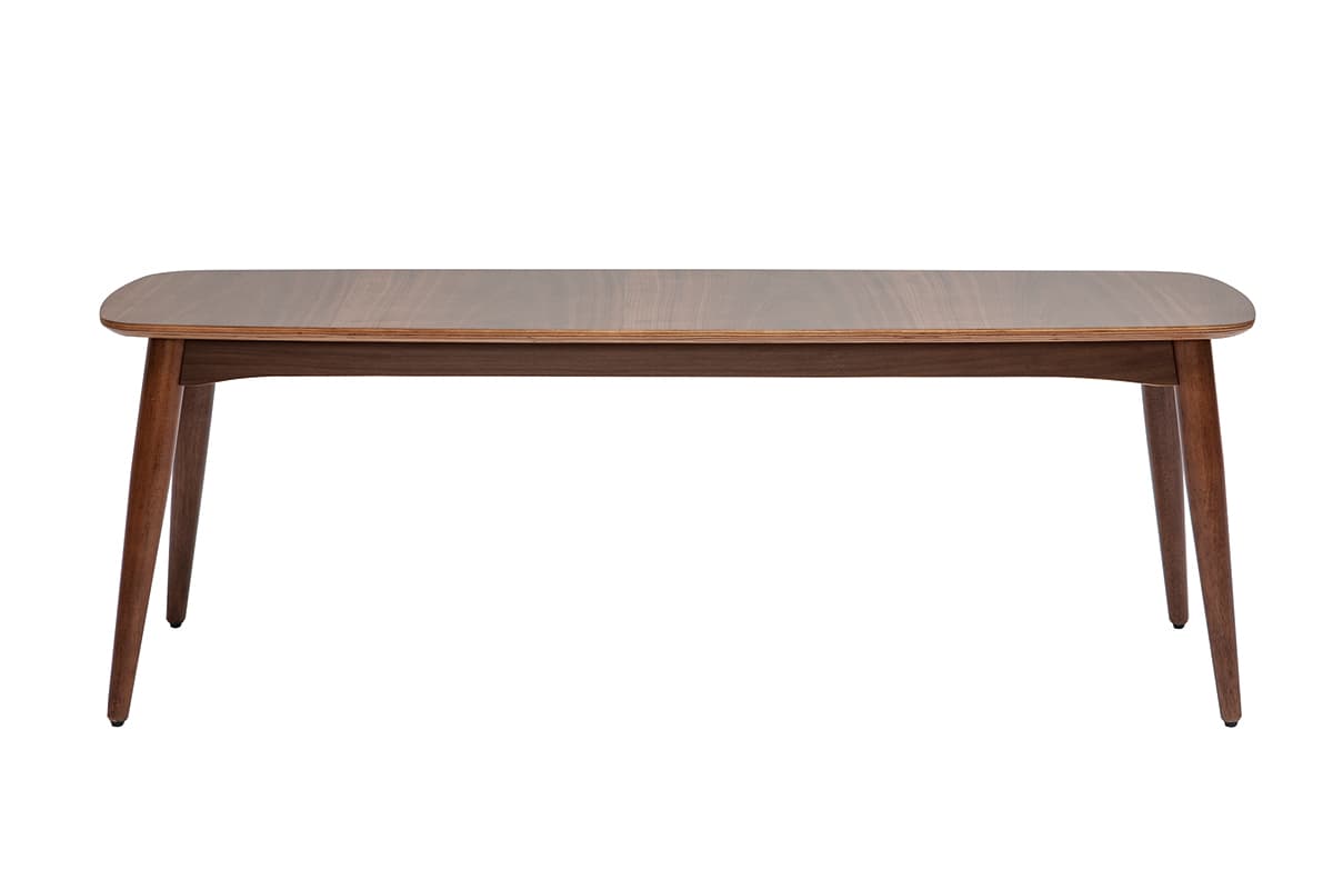 A rectangular coffee table with rounded corners and four tapered legs. The tabletop has a wood grain pattern and appears to be made of veneered wood or laminate. The legs are also wooden and are angled outwards. — 3D model