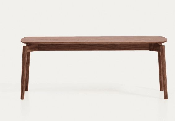A modern solid wood bench with a dark brown finish, featuring a rectangular top with rounded edges and four tapered, splayed legs. — 3D model