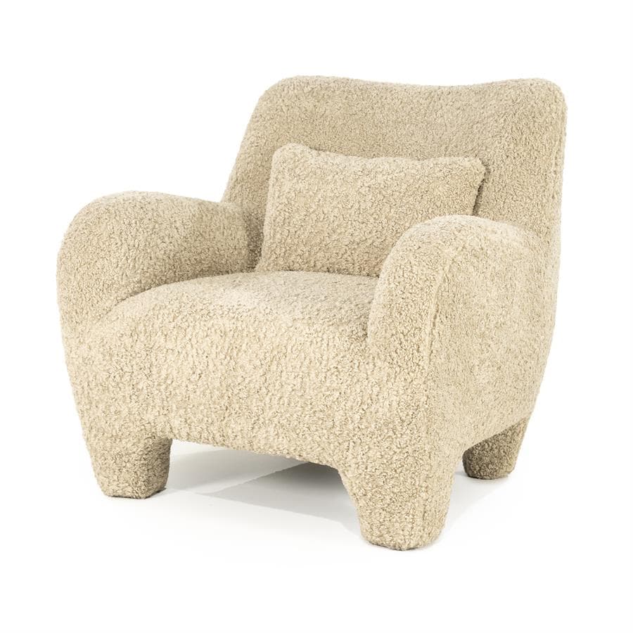 A cream-colored armchair with a rounded silhouette, upholstered in a textured fabric resembling boucle or sherpa. It features broad, enveloping arms, a high back, and four short, chunky legs. A small, square throw pillow with matching upholstery is placed on the seat against the back. — 3D model